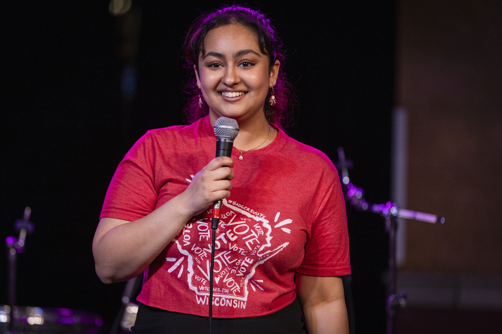 A woman speaks on a stage.