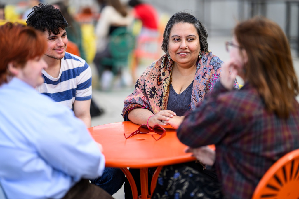 A woman speaks with some other people.