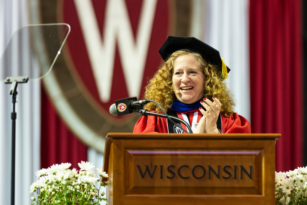 A woman speaks at a podium.