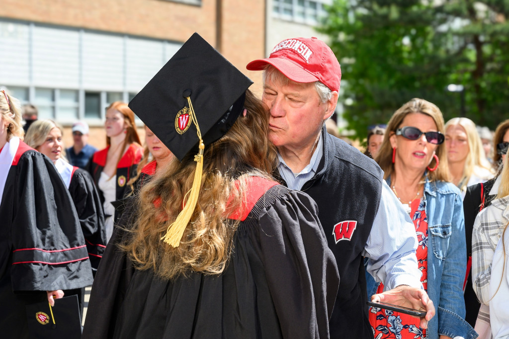 A father and daughter hug.