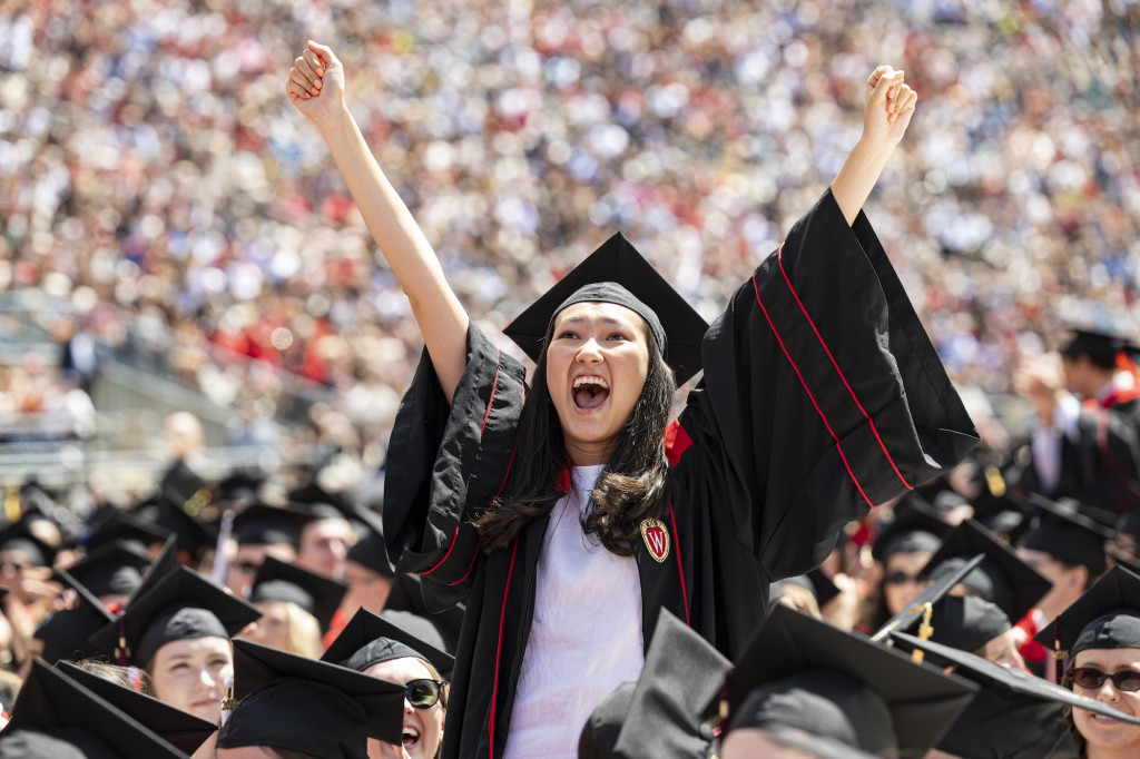 A woman holds up her hands in celebration.