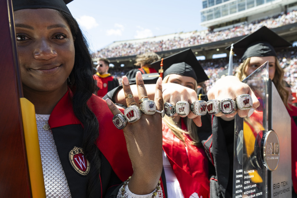 Several women hold up their hands, heavily adorned with rings.