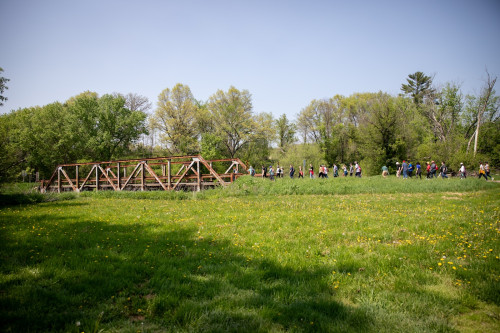 A group of people cross a bridge.