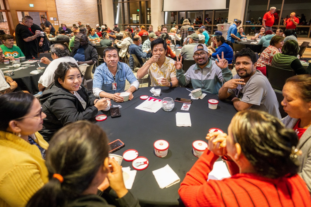 People gather around a table and enjoy ice cream.