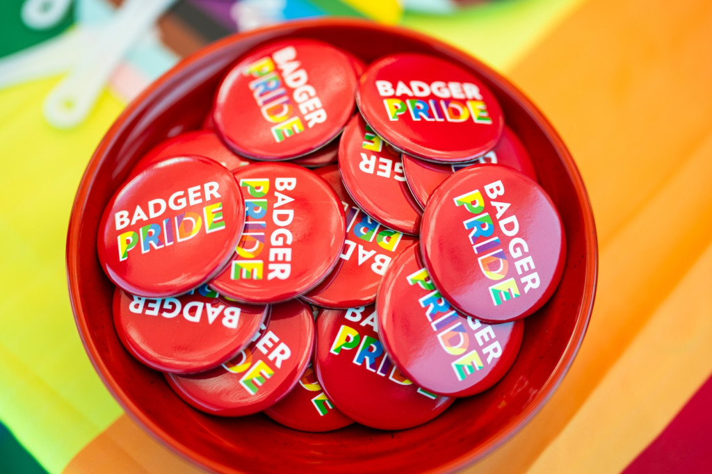 A bowl full of buttons that say Badger Pride Pride