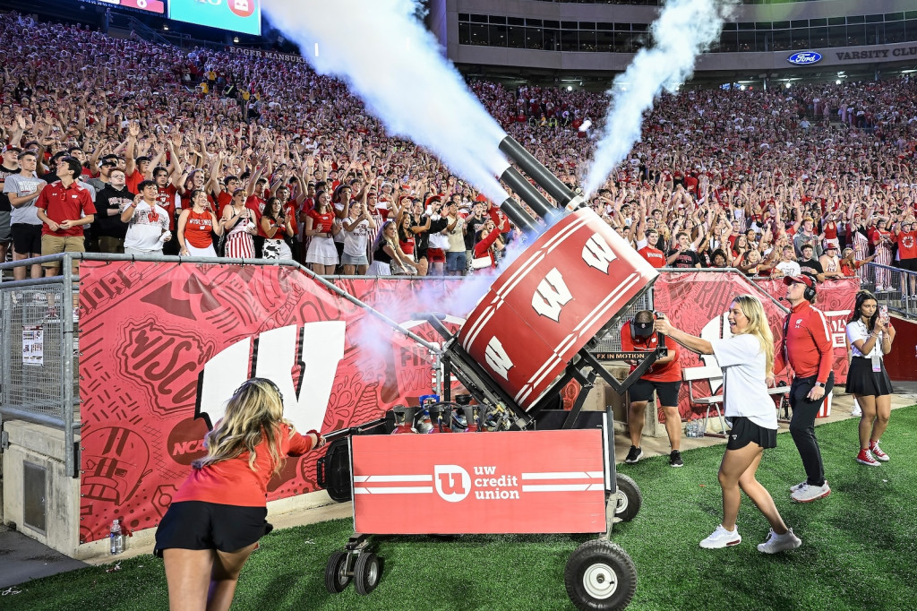 Women operate a machine shooting out steam and t-shirts.