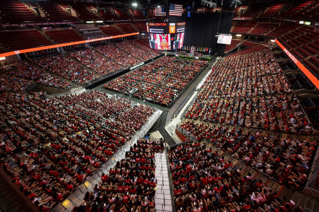 An arena is packed with people; shown from above.