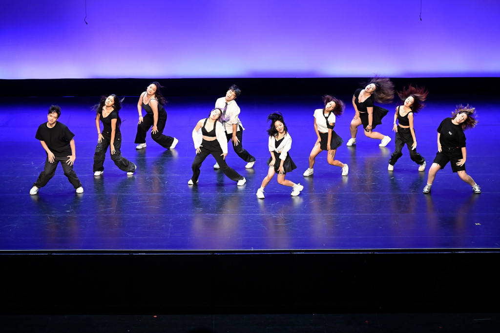 A group of people perform on stage.