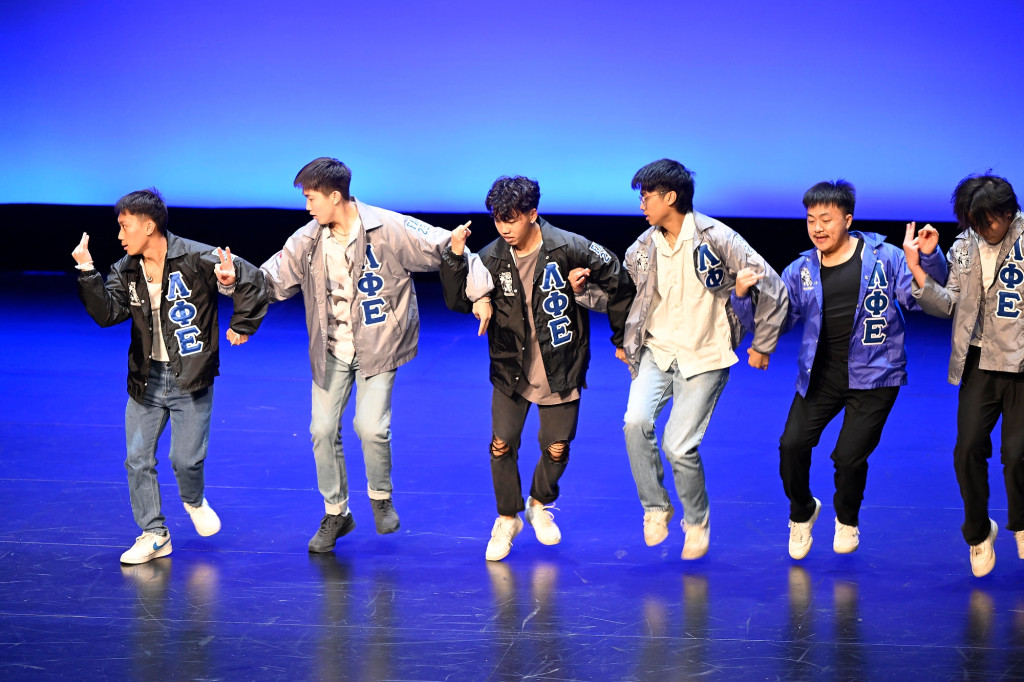 A group of people perform on stage.