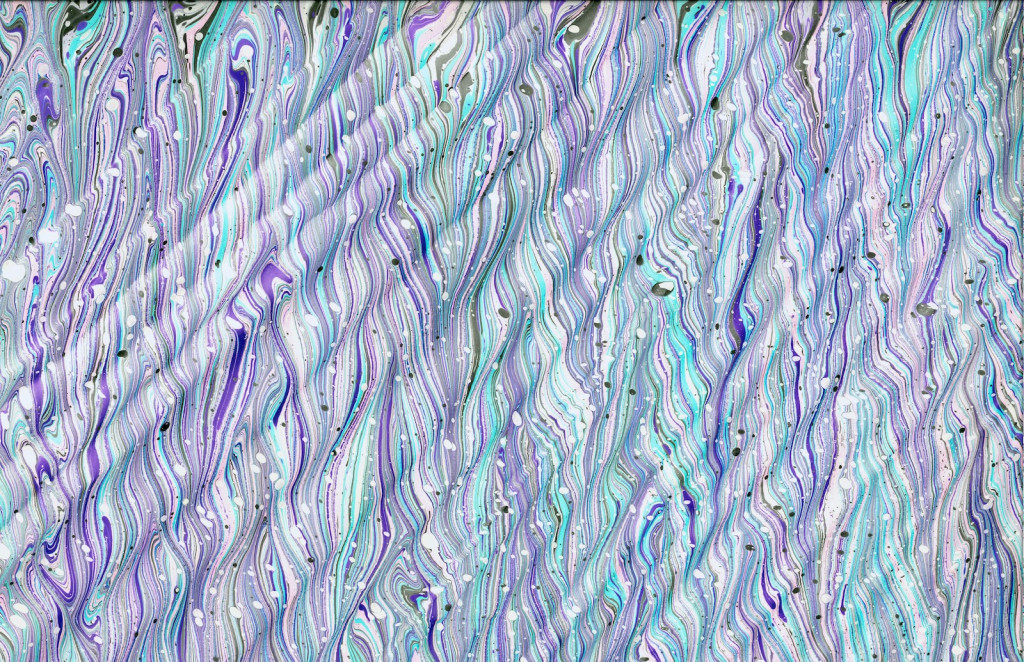 A pattern of purple and blue lines and waves run in artistic patterns.