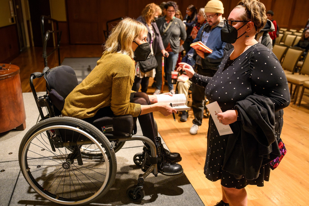 Taussig speaks to an audience member following the event.