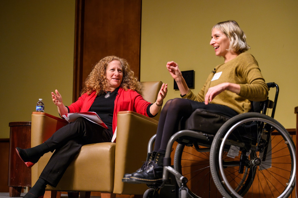 Chancellor Mnookin sits on stage with Rebekah Taussig, who uses a wheelchair, as they discuss Taussig's book Sitting Pretty.