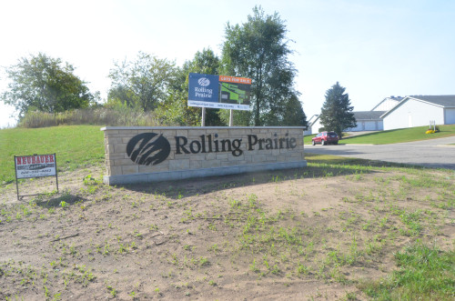 A sign in a field reads "Rolling Prairie."