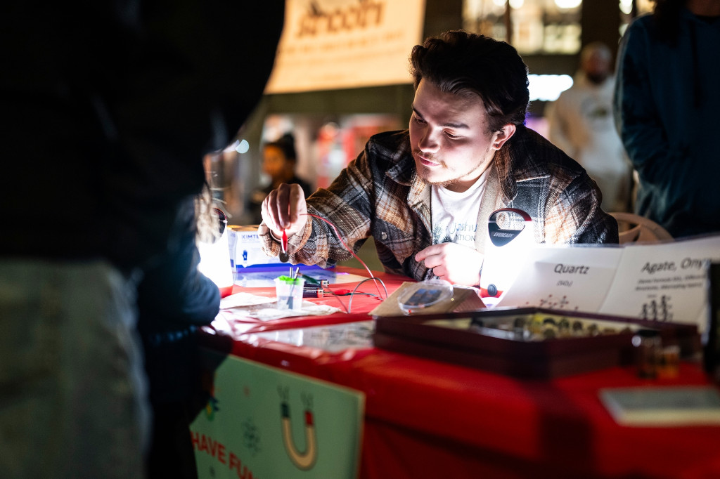 A man performs a scientific experiment with lab equipment.