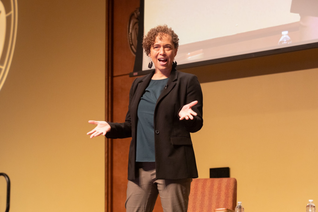 A woman speaks to an audience.