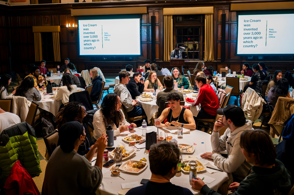 People sitting around a table eat and talk.