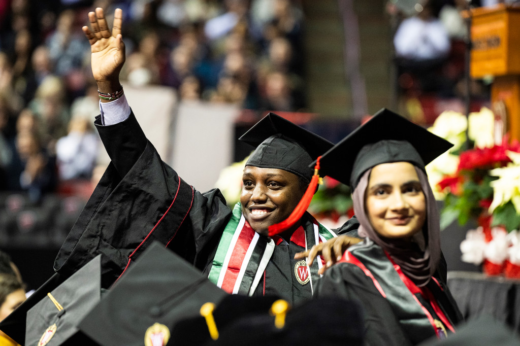 Graduates wave to friends and family members.