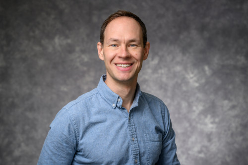 A man smiles at the camera.