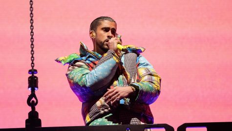 Bad Bunny, wearing a colorful jacket, performs at the Coachella Music & Arts Festival.